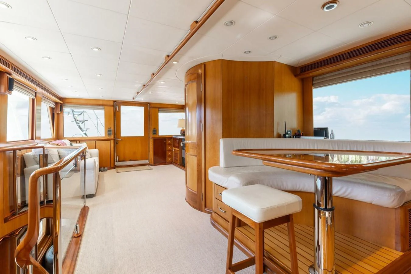 The yacht's interior features a spacious and well-lit area with elegant wooden finishes and comfortable seating. aboard AURELIA Yacht for Sale