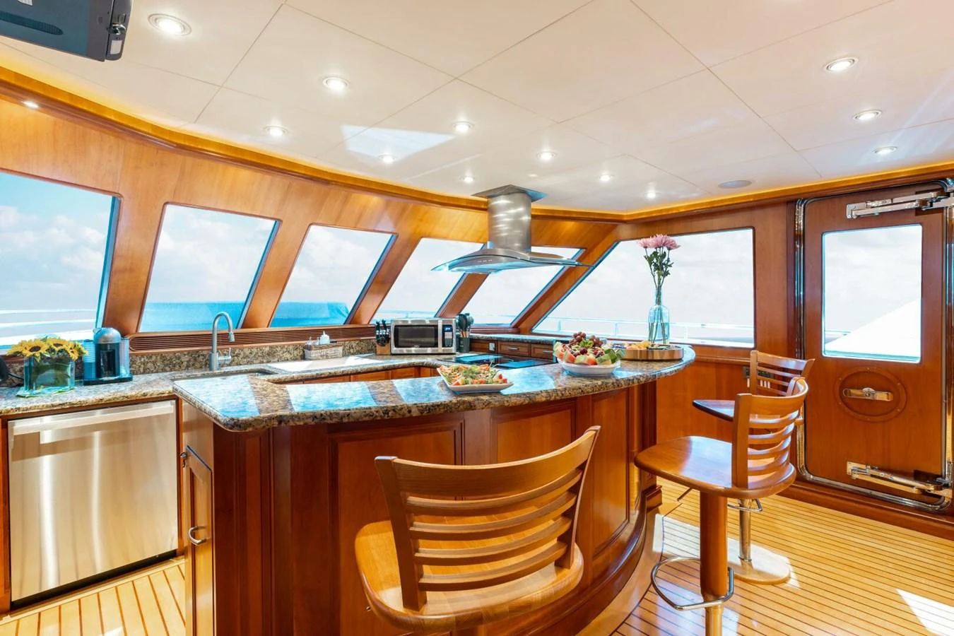 The yacht's galley features a luxurious and well-lit space with modern appliances and elegant wooden finishes. aboard AURELIA Yacht for Sale