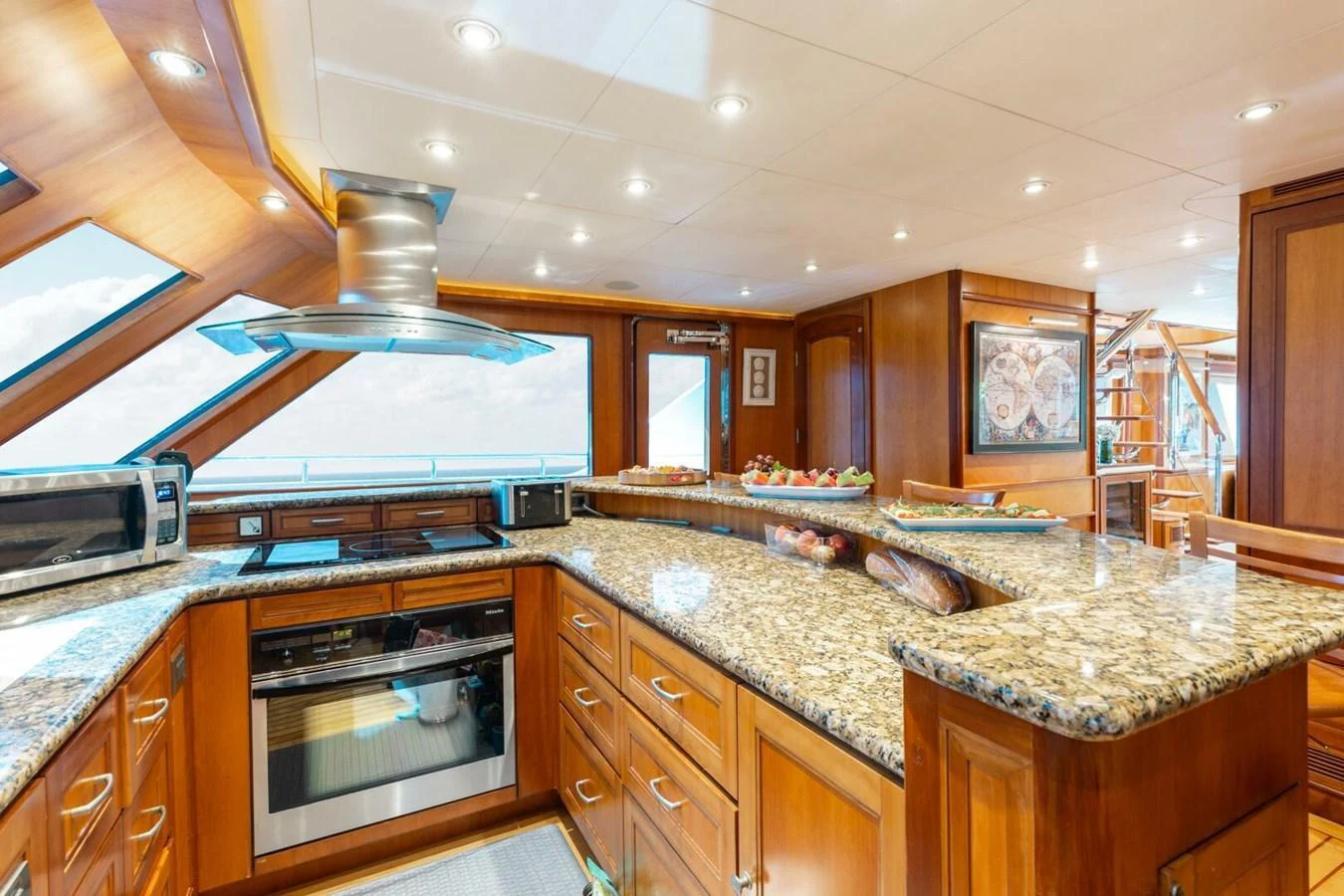 The yacht's galley features a spacious and well-lit area with modern appliances and elegant wooden cabinetry. aboard AURELIA Yacht for Sale