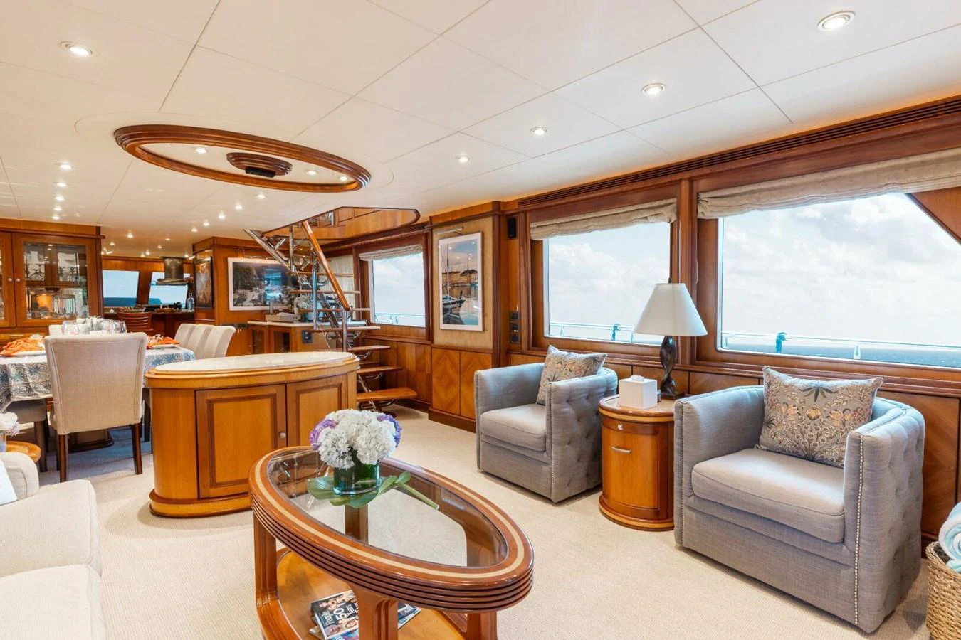The yacht's salon features elegant furnishings and large windows offering panoramic views. aboard AURELIA Yacht for Sale