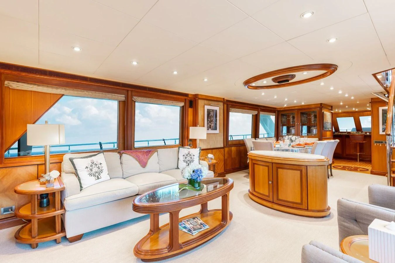 The salon features elegant furnishings and expansive windows offering stunning ocean views. aboard AURELIA Yacht for Sale