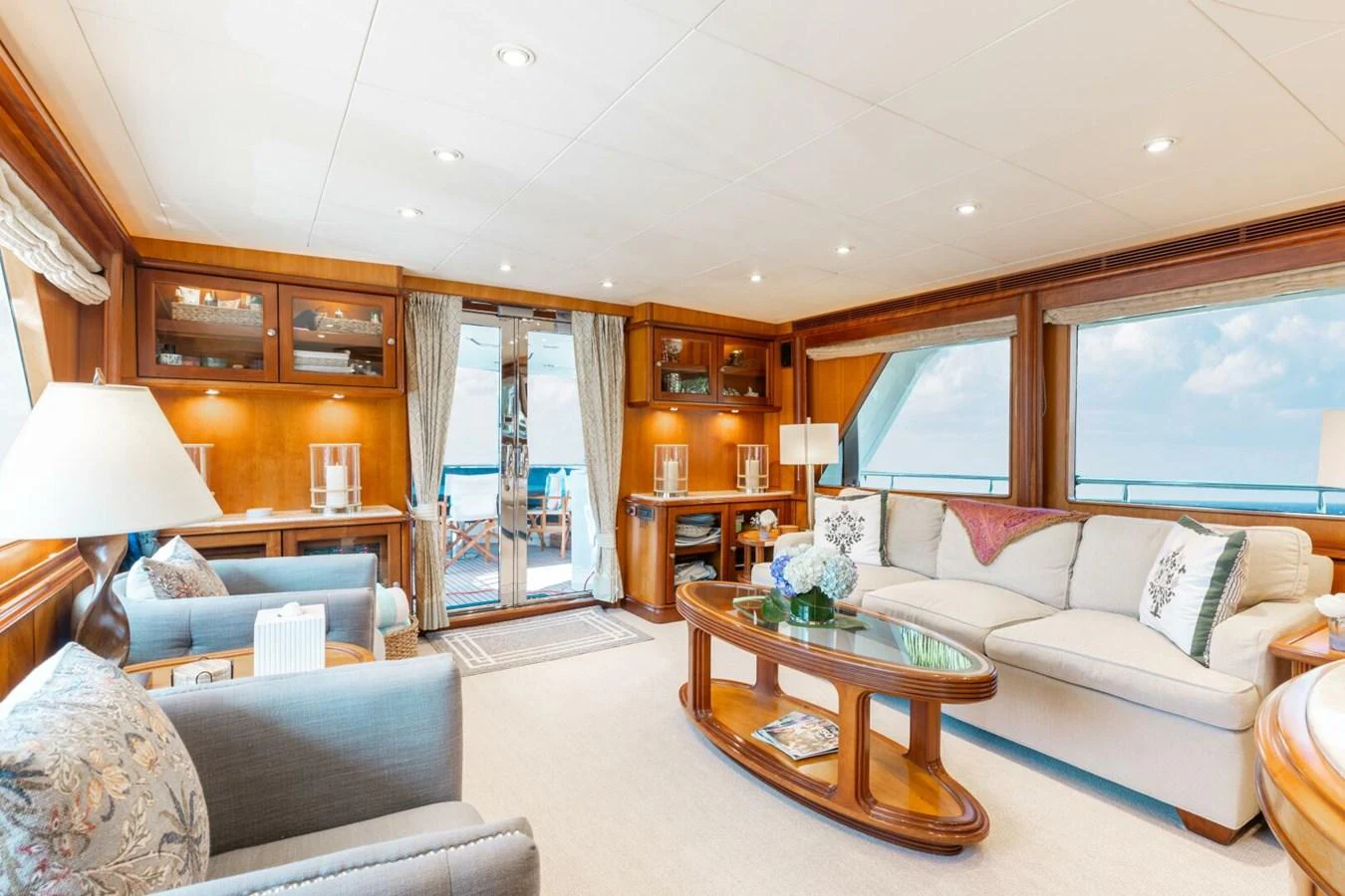 The salon offers a spacious and elegant area with comfortable seating and large windows providing ample natural light. aboard AURELIA Yacht for Sale