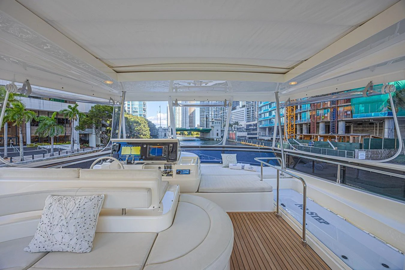 The flybridge offers a spacious and luxurious seating area with a view of the marina. aboard NORAL Yacht for Sale