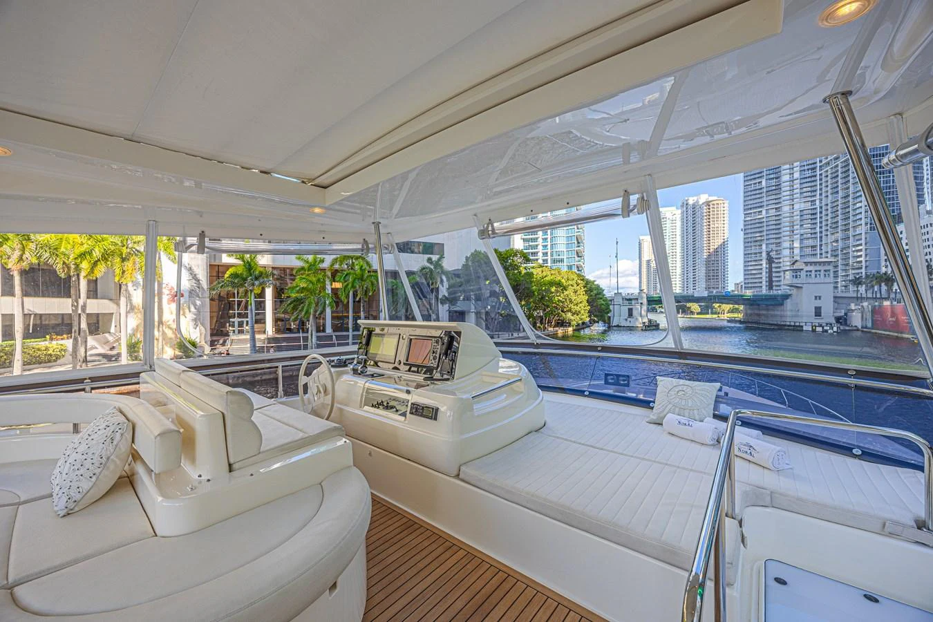 The helm area offers a spacious and comfortable environment with a view of the city skyline. aboard NORAL Yacht for Sale
