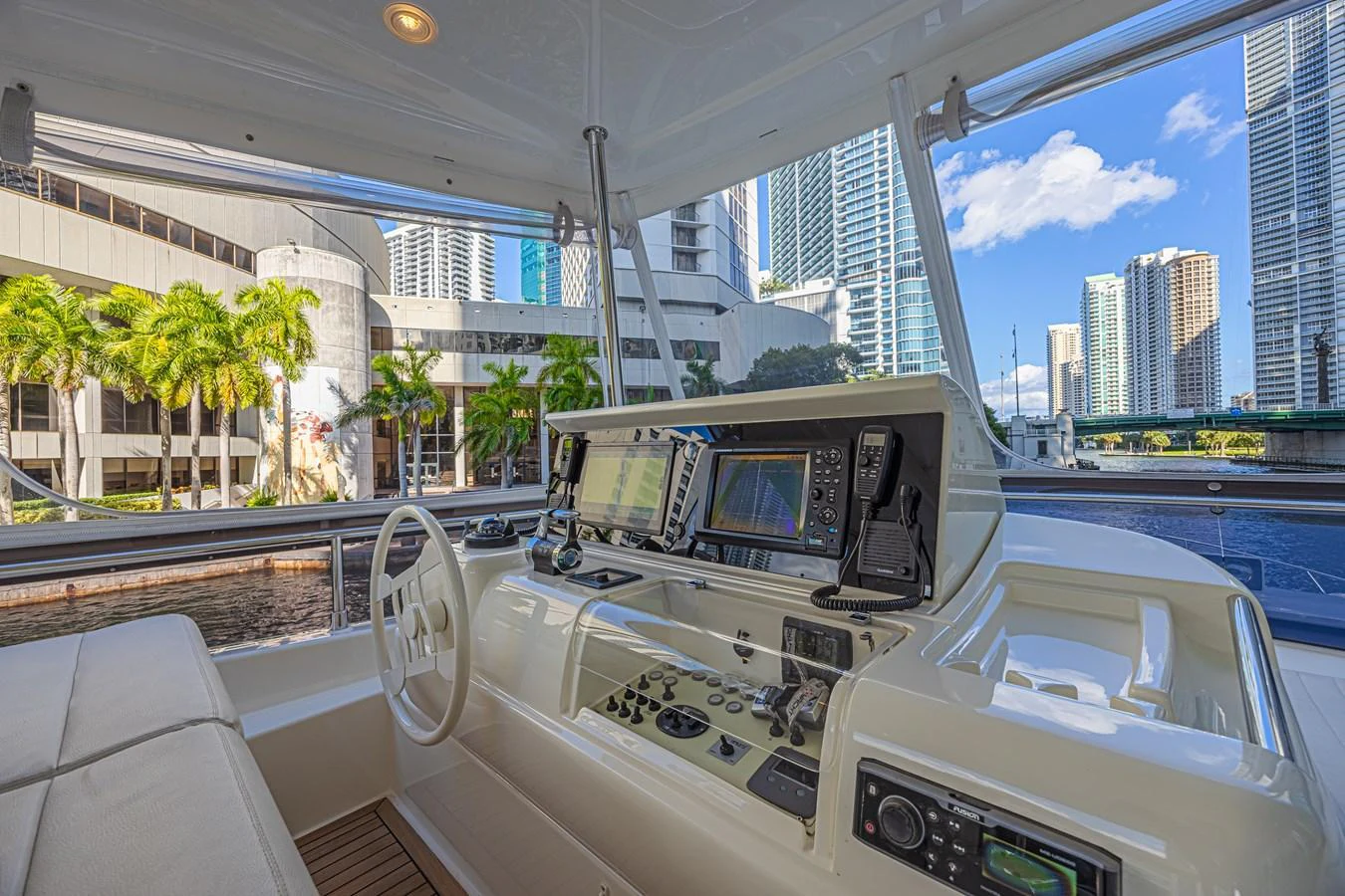The helm station offers a modern and well-equipped control area with a scenic city view. aboard NORAL Yacht for Sale