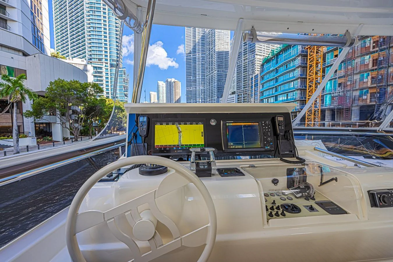 The helm station offers a modern and well-equipped control area with a stunning cityscape view. aboard NORAL Yacht for Sale