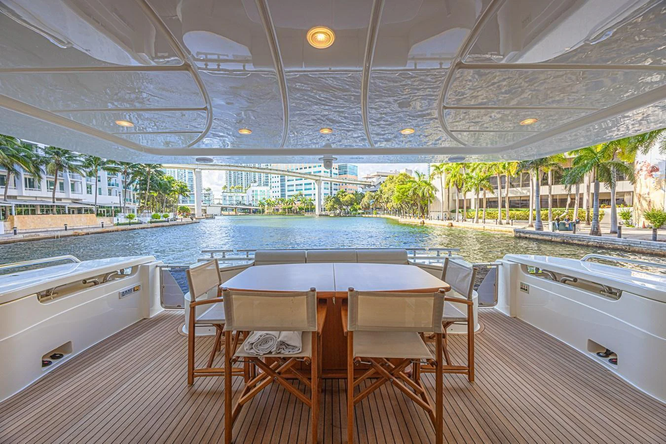 The aft deck features a spacious dining area with a stunning waterfront view. aboard NORAL Yacht for Sale