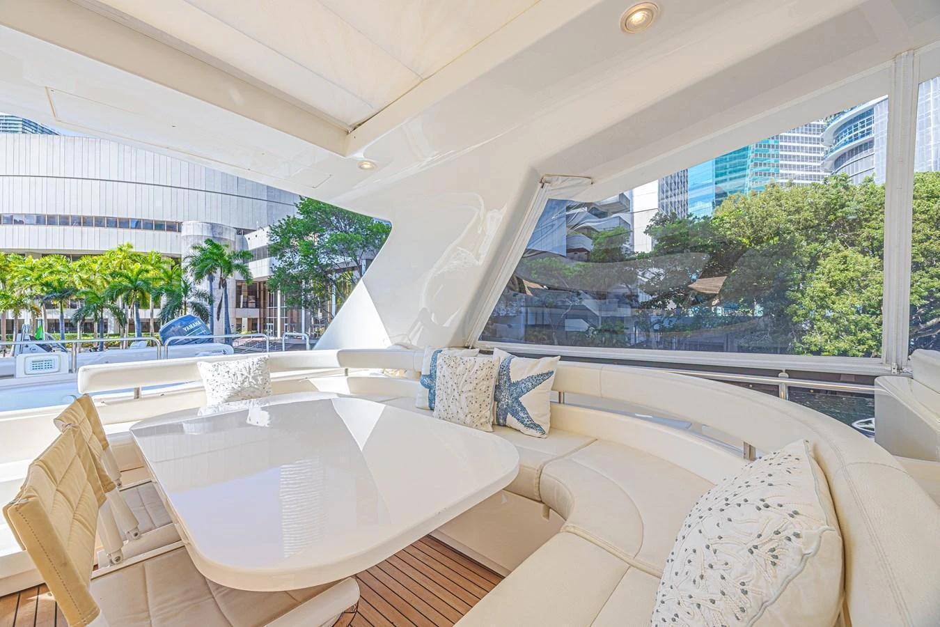 The aft deck features a spacious seating area with a sleek dining table, perfect for alfresco dining. aboard NORAL Yacht for Sale