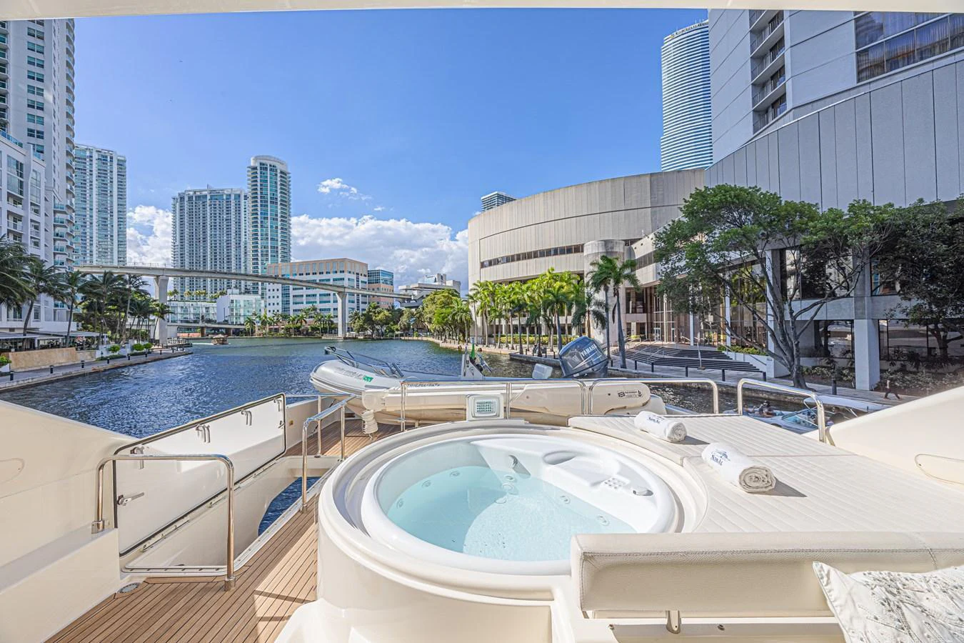 The yacht features a luxurious jacuzzi deck with stunning cityscape views. aboard NORAL Yacht for Sale