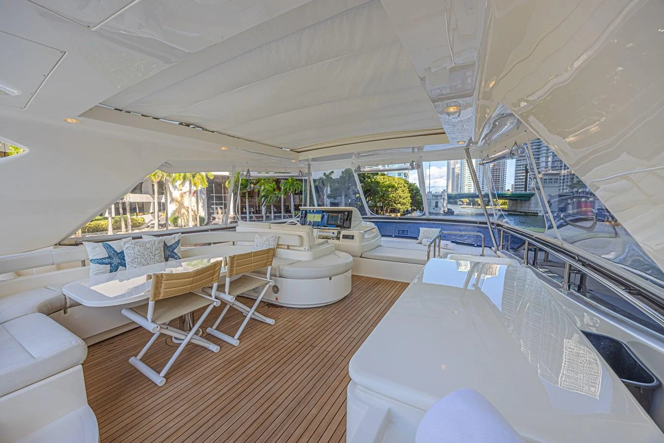The aft deck features a spacious seating area with a dining table and comfortable chairs, perfect for alfresco dining and relaxation. aboard NORAL Yacht for Sale
