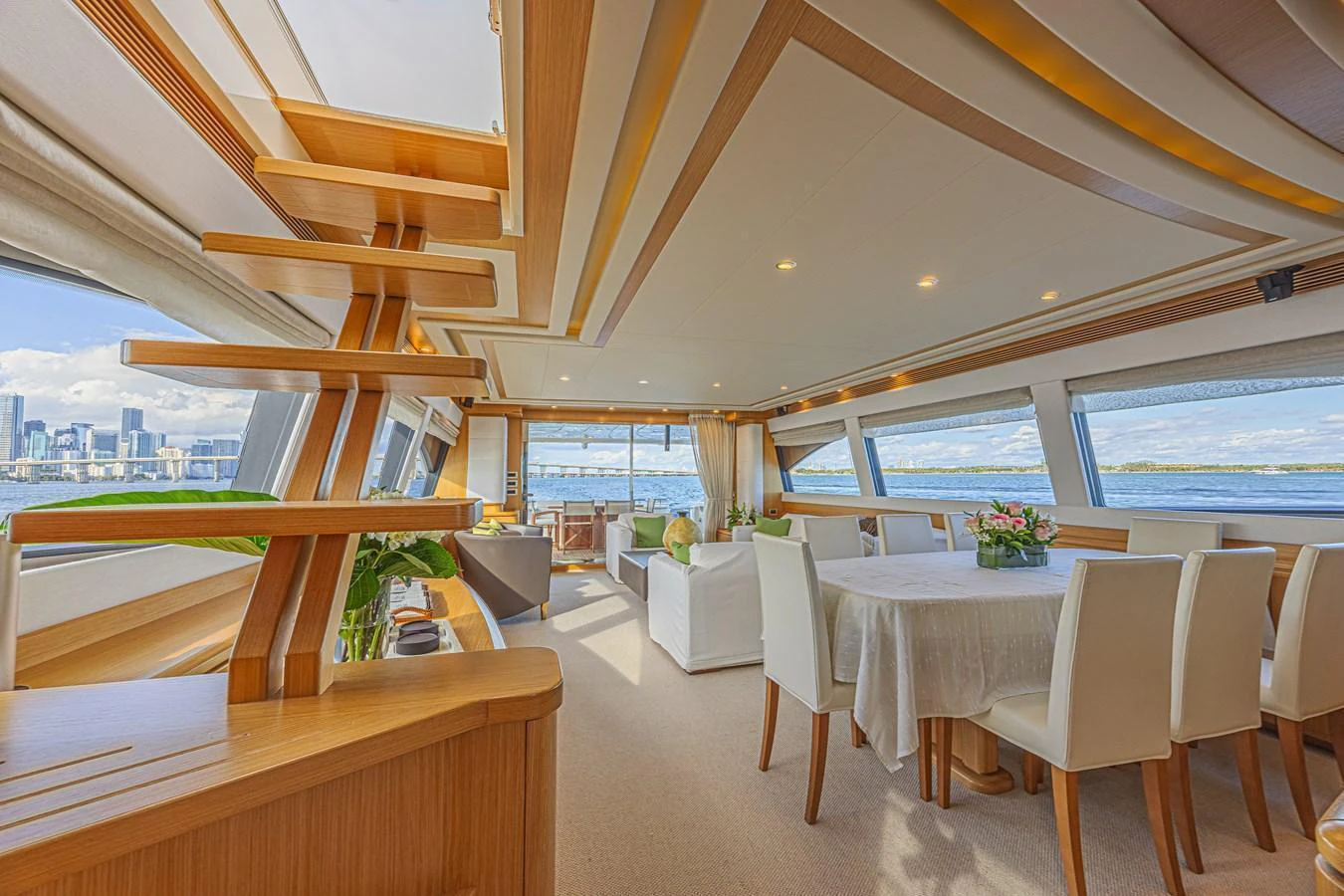 The spacious salon features elegant dining and lounging areas with panoramic views. aboard NORAL Yacht for Sale