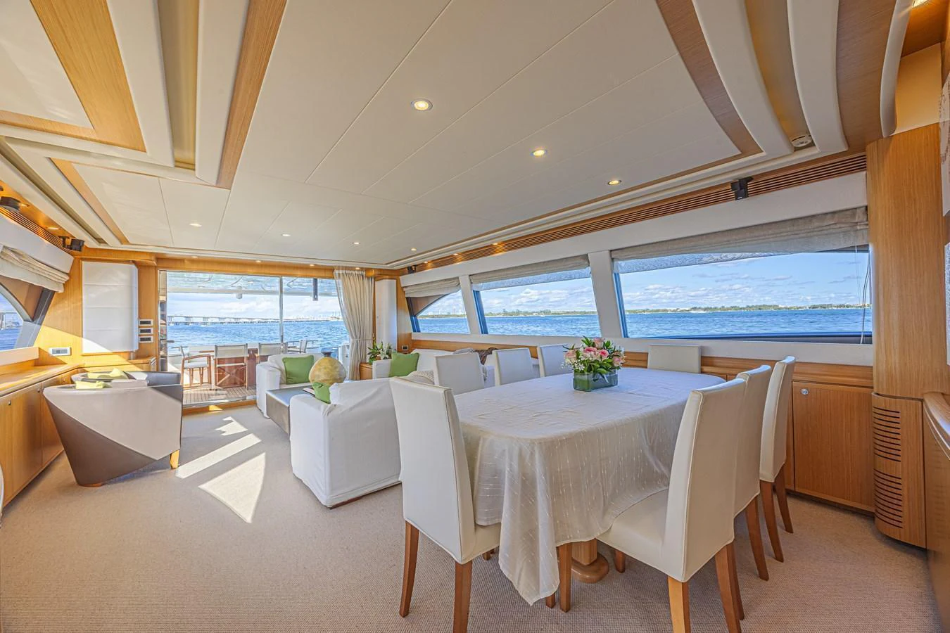 The salon features a spacious dining area with large windows offering stunning sea views. aboard NORAL Yacht for Sale