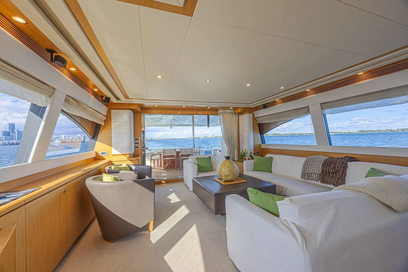 The spacious salon features large windows, comfortable seating, and elegant decor, offering a luxurious and inviting atmosphere. aboard NORAL Yacht for Sale