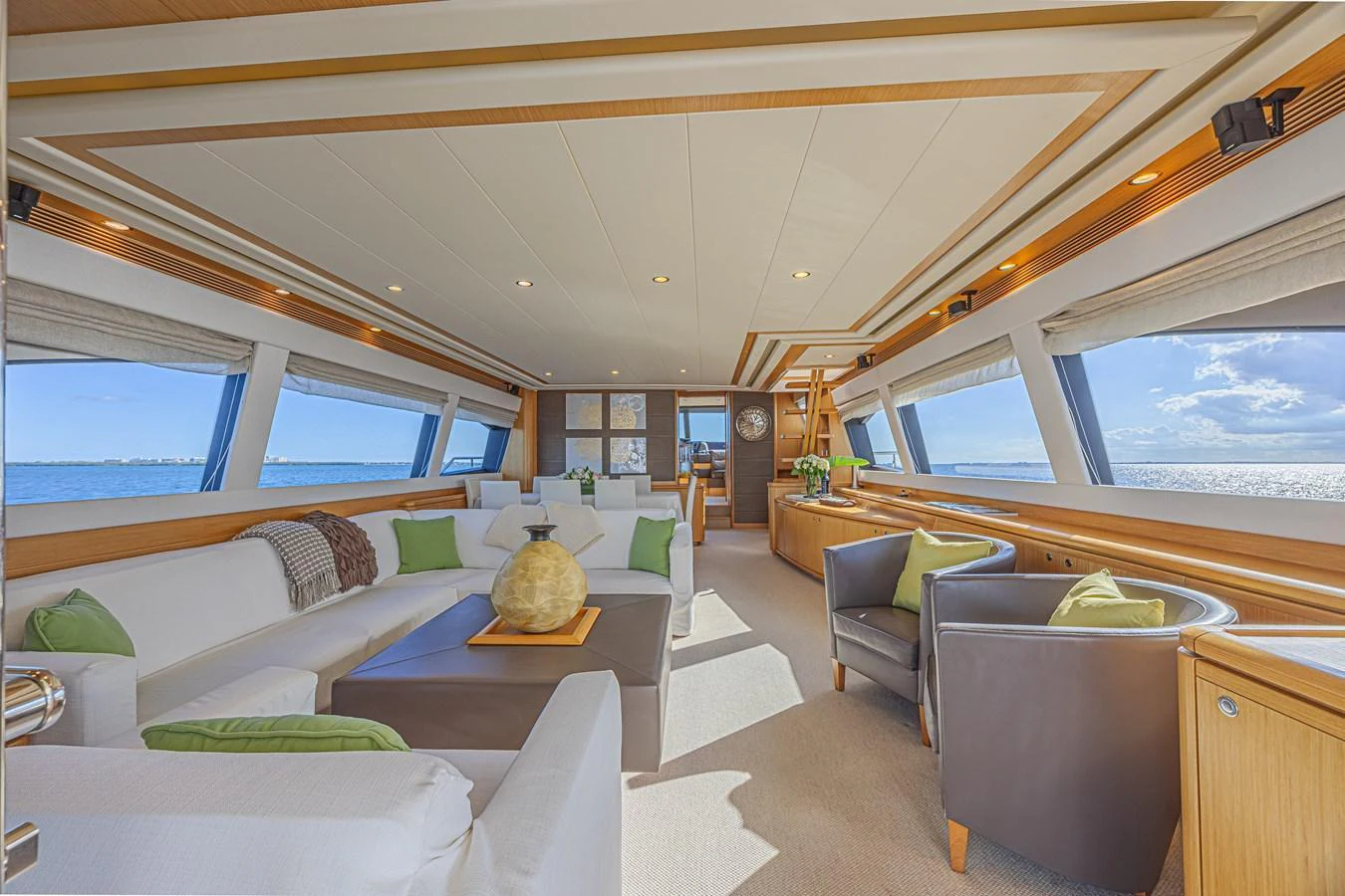 The spacious salon features elegant seating with panoramic ocean views. aboard NORAL Yacht for Sale