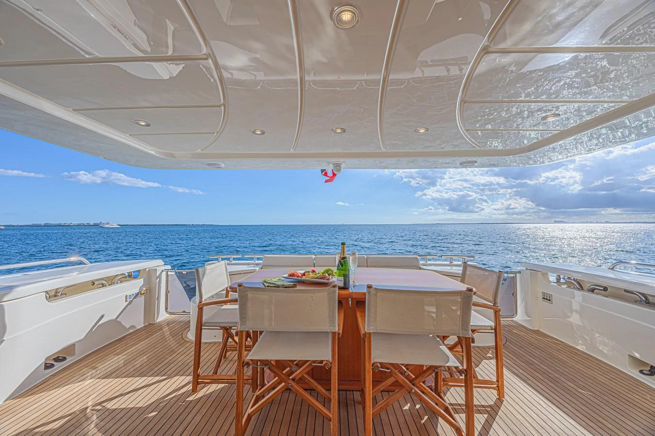 The aft deck offers a stunning dining area with a panoramic ocean view. aboard NORAL Yacht for Sale