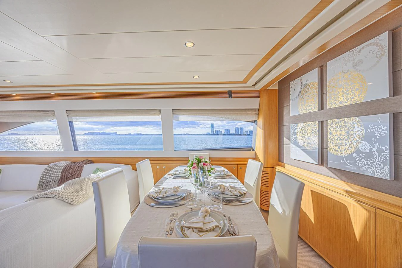 The yacht's dining area features elegant table settings and panoramic ocean views through large windows. aboard NORAL Yacht for Sale