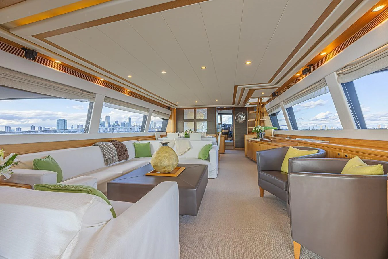 The spacious salon features plush seating and panoramic windows, offering a luxurious and comfortable environment with stunning views. aboard NORAL Yacht for Sale