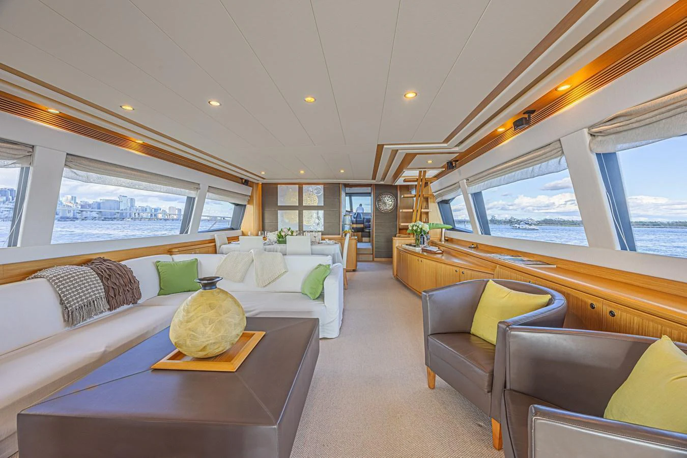 The salon features plush seating and expansive windows for a luxurious and comfortable experience. aboard NORAL Yacht for Sale
