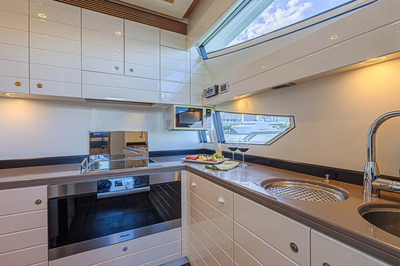 The yacht's galley is modern and well-equipped, featuring sleek cabinetry and ample natural light. aboard NORAL Yacht for Sale