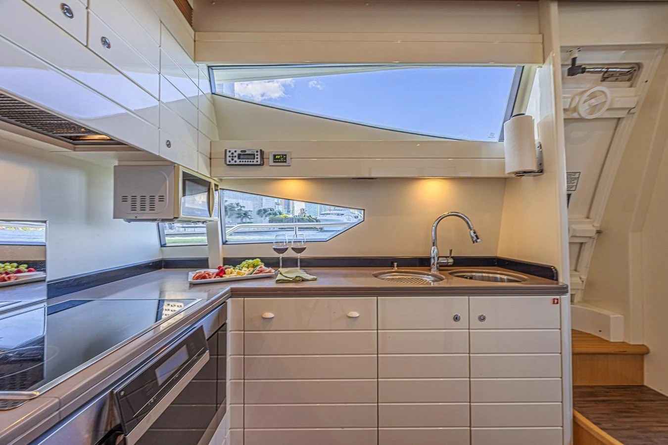 The yacht's galley is equipped with modern appliances and ample counter space, bathed in natural light from the large windows. aboard NORAL Yacht for Sale