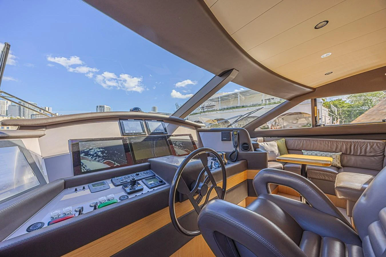 The helm station features modern navigation equipment and a comfortable seating area with panoramic views. aboard NORAL Yacht for Sale