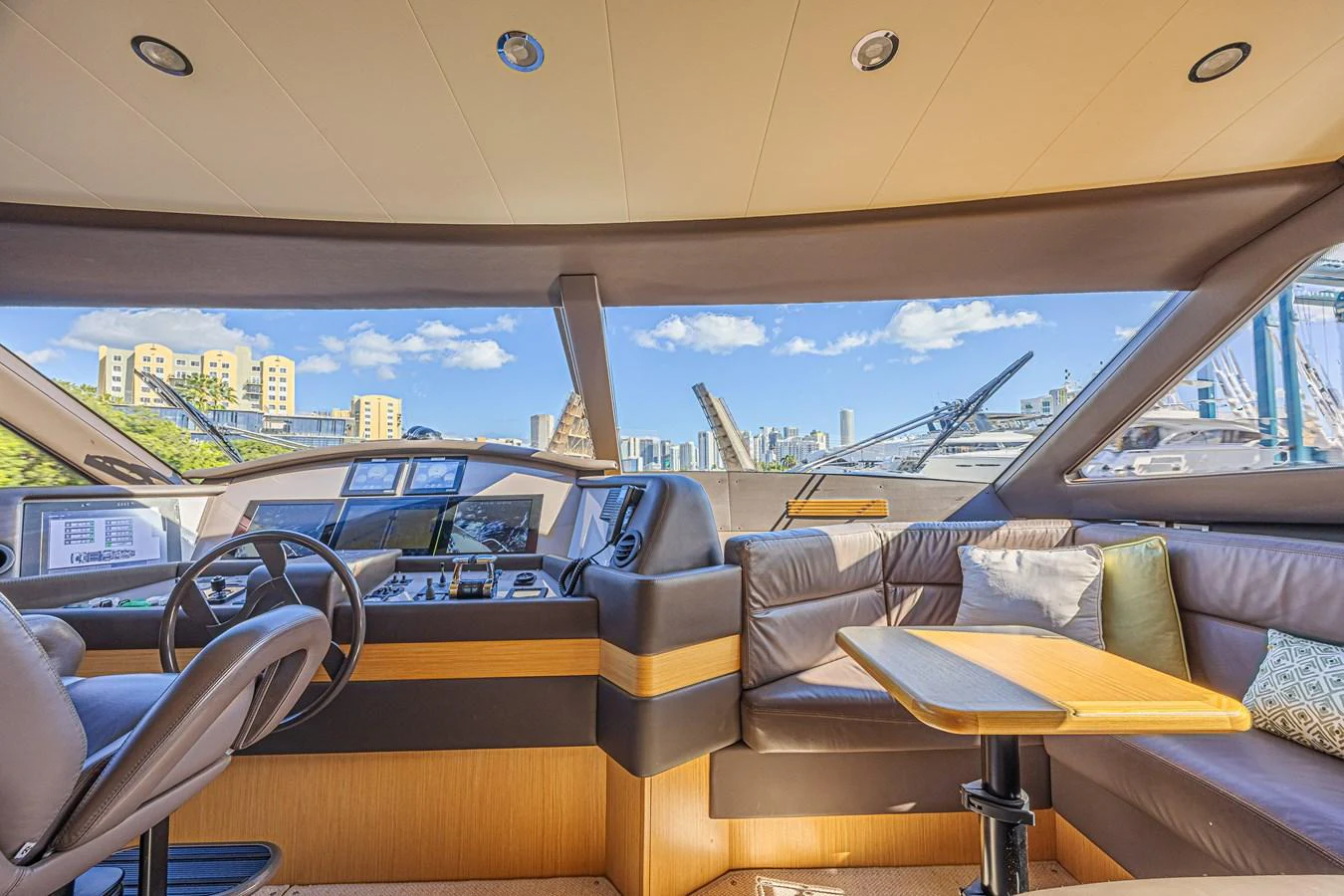 The helm area features a comfortable seating arrangement with a panoramic view of the marina. aboard NORAL Yacht for Sale