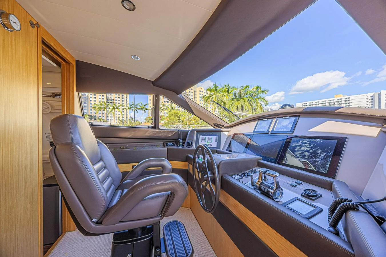 The helm station features luxurious seating and state-of-the-art navigation equipment, with large windows offering panoramic views. aboard NORAL Yacht for Sale