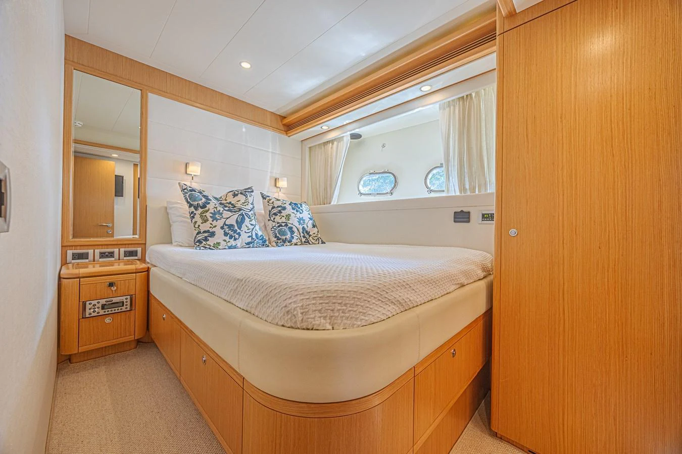 A cozy stateroom with a large bed and elegant wooden furnishings. aboard NORAL Yacht for Sale
