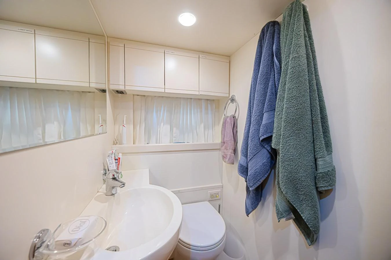 The yacht's bathroom features a clean and functional design with ample storage and soft lighting. aboard NORAL Yacht for Sale