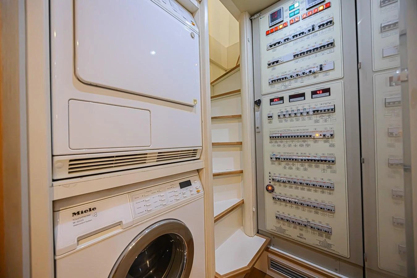 The yacht's laundry room features modern appliances and an organized control panel. aboard NORAL Yacht for Sale