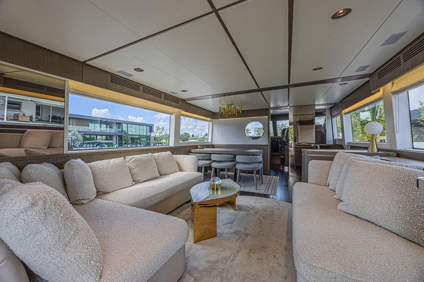 The salon features plush seating, a modern dining area, and large windows for natural light. aboard XAX66M61L122 Yacht for Sale
