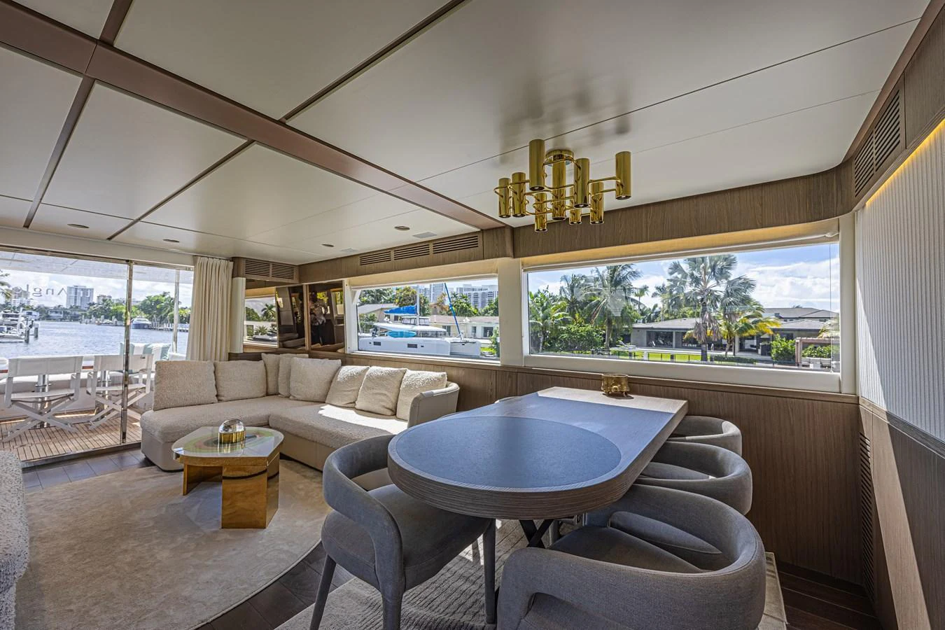 The salon features a spacious seating area with large windows offering scenic views. aboard XAX66M61L122 Yacht for Sale