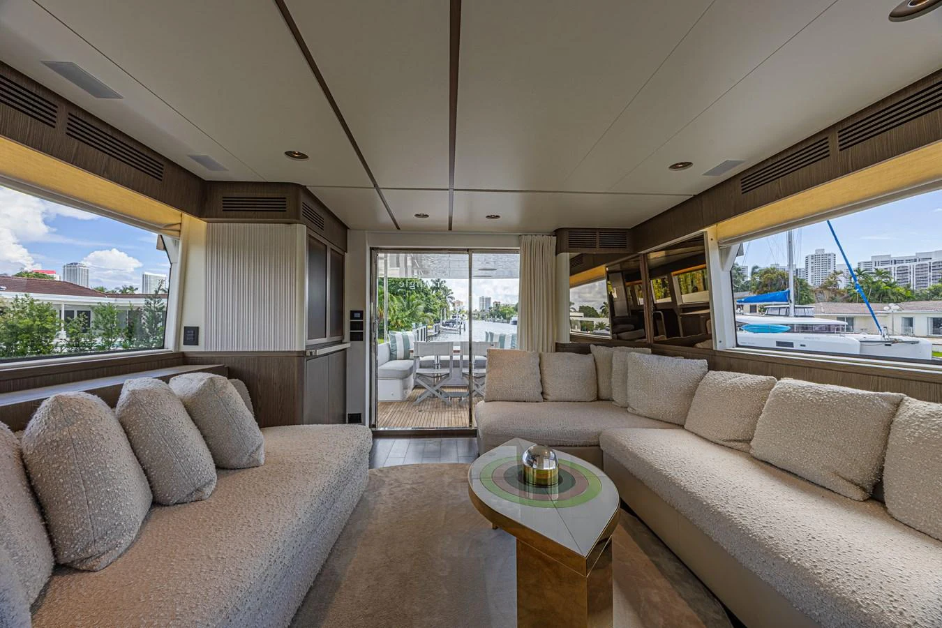 The salon features plush seating and large windows, offering a comfortable and inviting space. aboard XAX66M61L122 Yacht for Sale