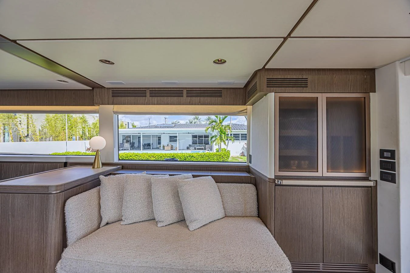 The salon features a cozy seating area with large windows offering a view of the surroundings. aboard XAX66M61L122 Yacht for Sale