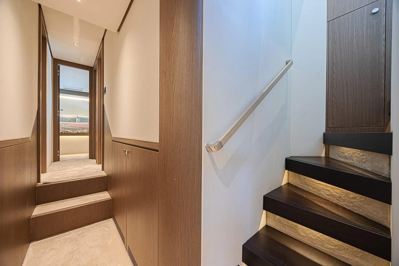 A sleek and modern hallway with a staircase leading to another level. aboard XAX66M61L122 Yacht for Sale