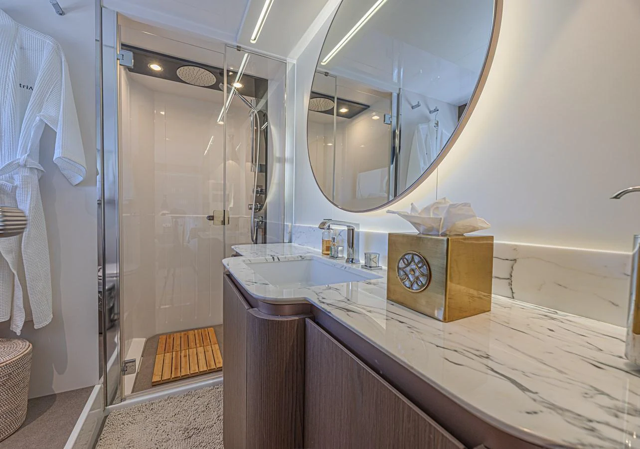 The yacht's bathroom features a modern design with a spacious shower and elegant fixtures. aboard XAX66M61L122 Yacht for Sale