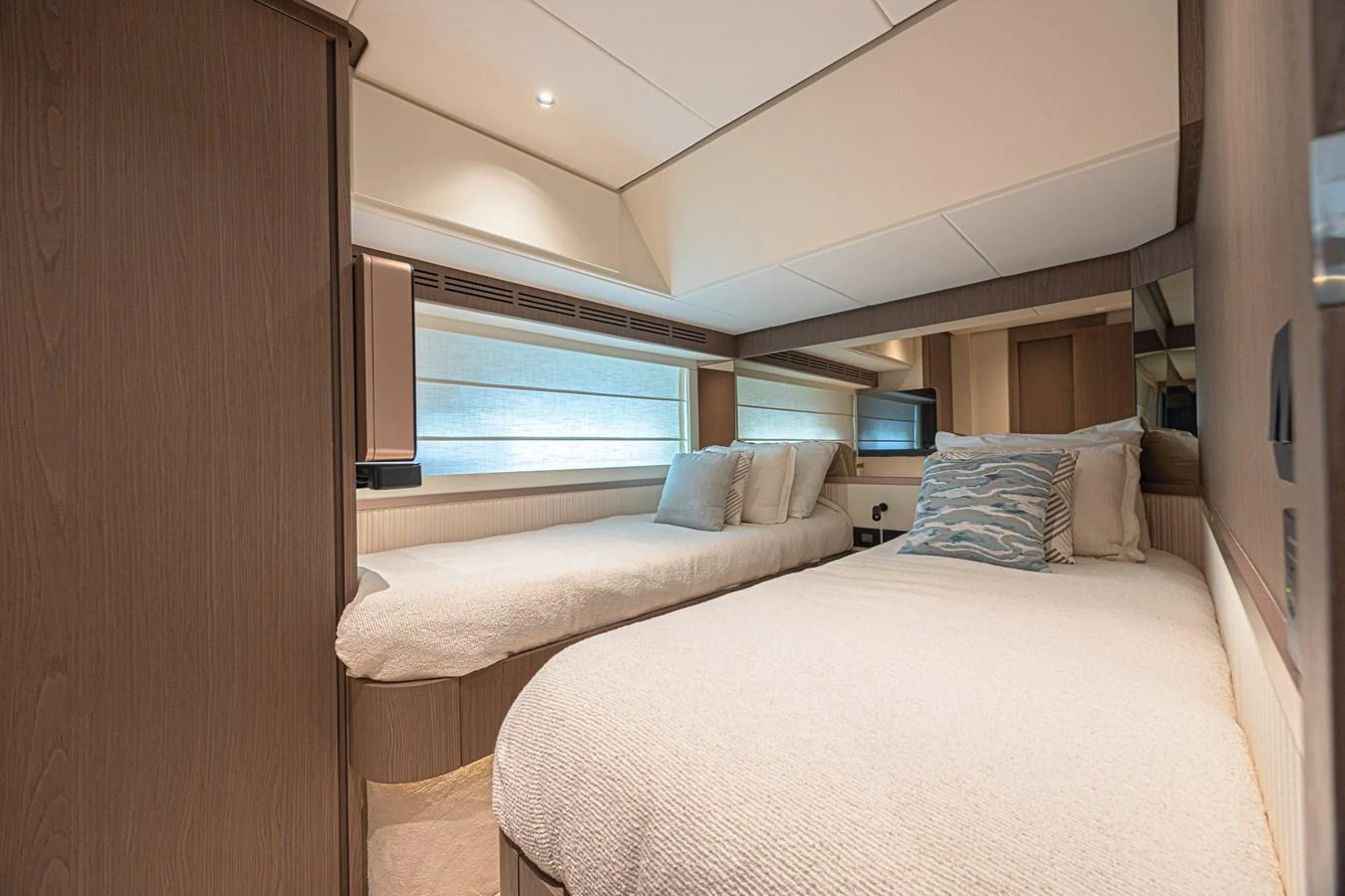 The guest stateroom offers twin beds with elegant bedding and ample natural light. aboard XAX66M61L122 Yacht for Sale