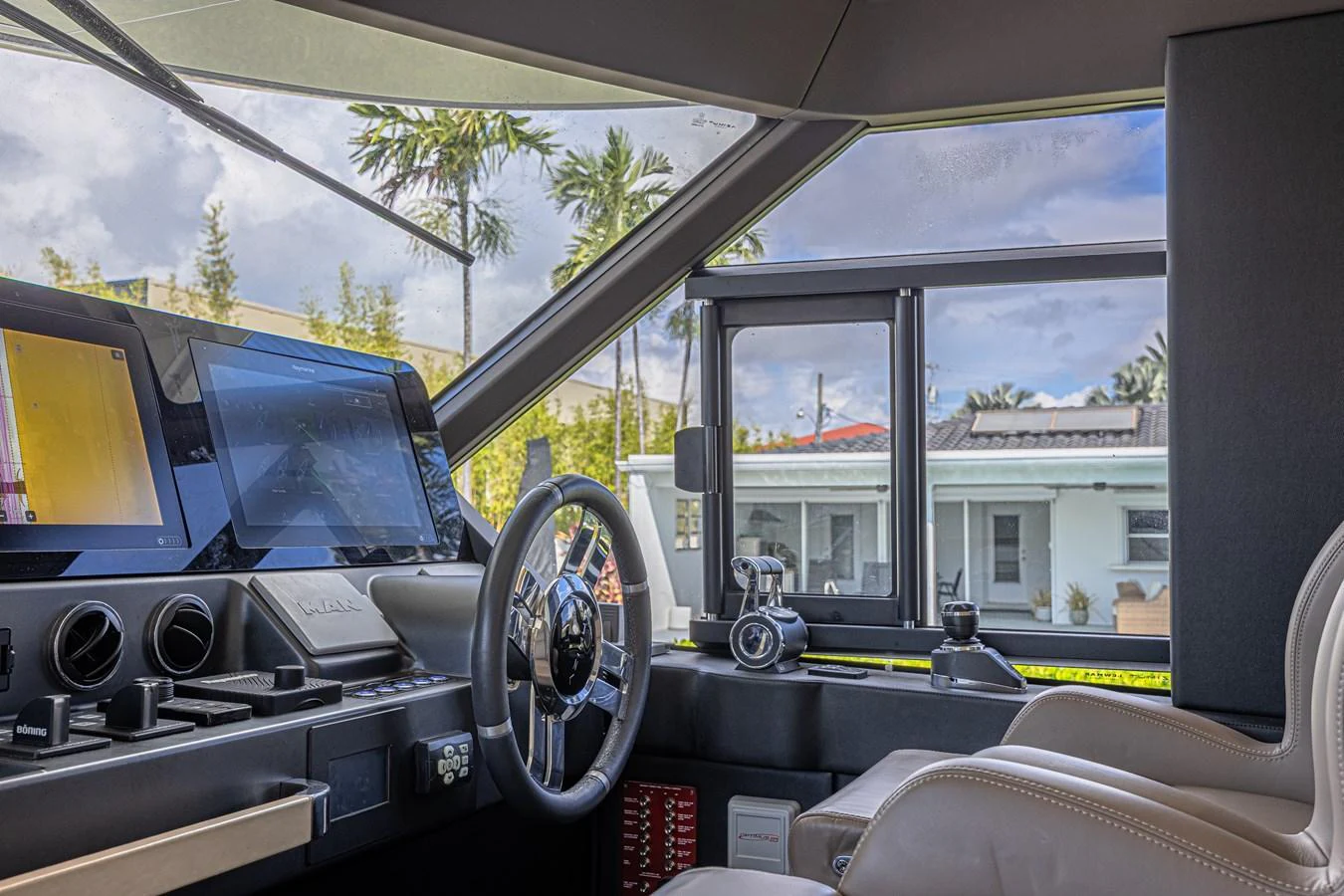 The helm station features advanced navigation equipment and a comfortable captain's chair, offering a commanding view through large windows. aboard XAX66M61L122 Yacht for Sale