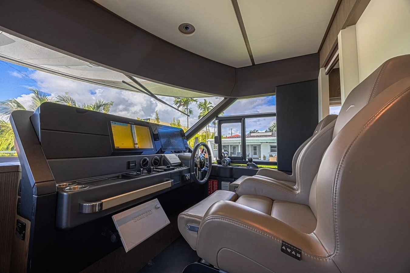 The helm station features modern navigation equipment and comfortable seating. aboard XAX66M61L122 Yacht for Sale