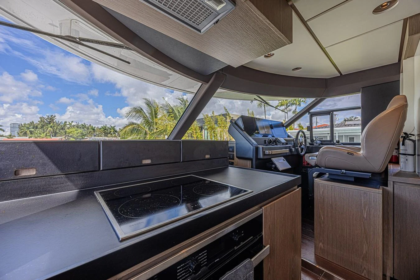 The helm area features modern navigation equipment and a sleek design. aboard XAX66M61L122 Yacht for Sale