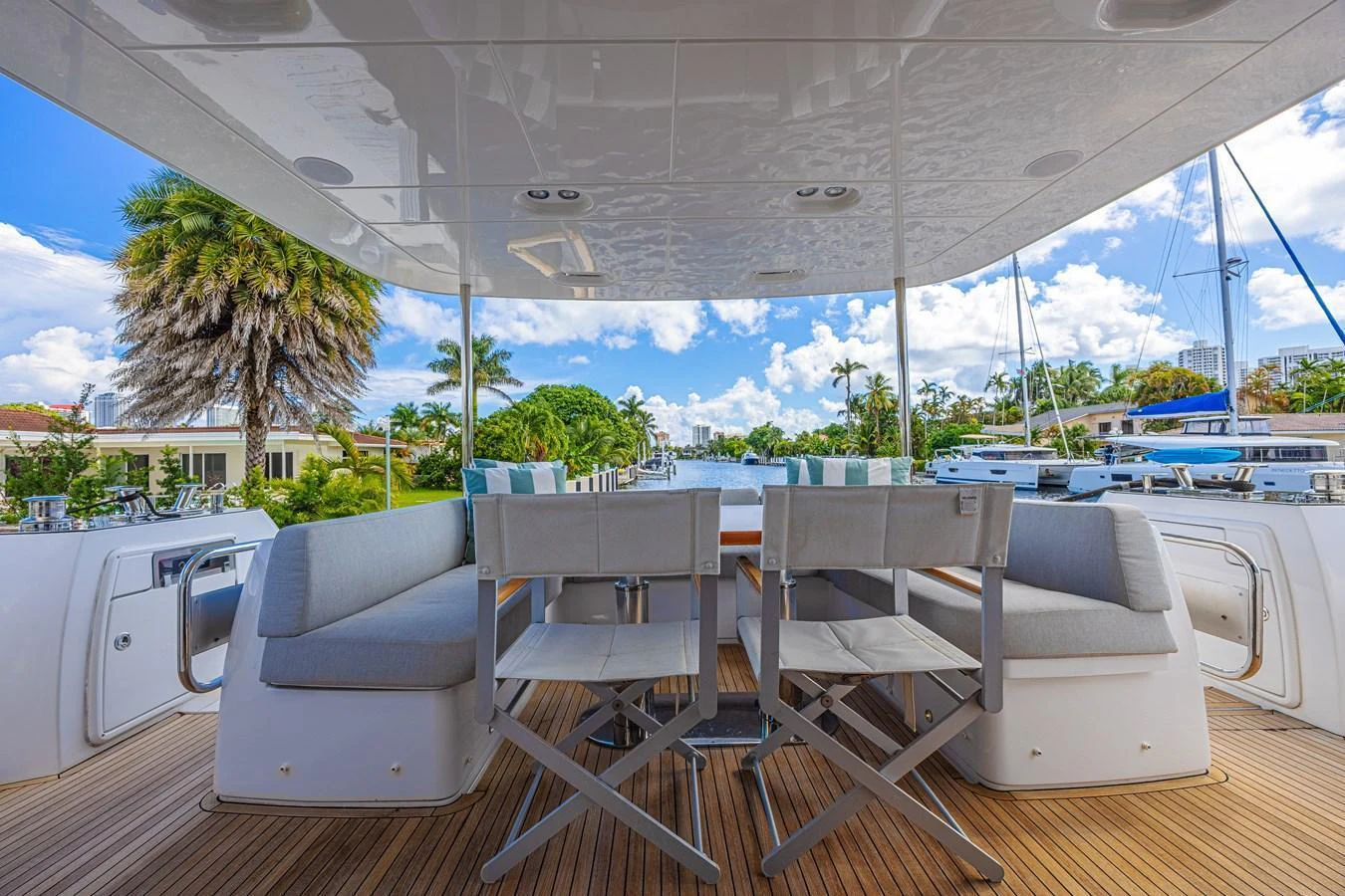 The aft deck offers a spacious and comfortable seating area with a beautiful view of the surroundings. aboard XAX66M61L122 Yacht for Sale