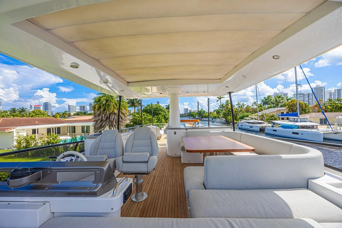 The flybridge offers a spacious and comfortable outdoor seating area with a view of the marina. aboard XAX66M61L122 Yacht for Sale