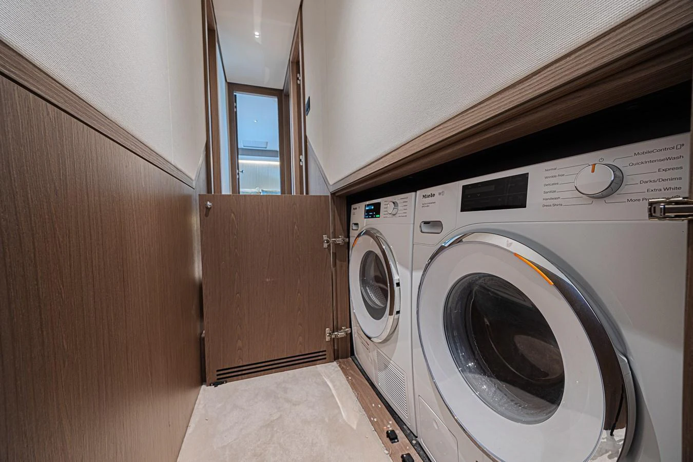 The yacht features a compact and efficient laundry room with modern appliances. aboard XAX66M61L122 Yacht for Sale