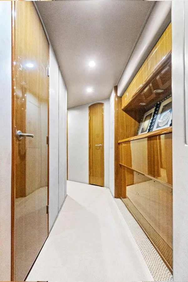 a hallway with a white floor and wood cabinets aboard VKY74038A808 Yacht for Sale