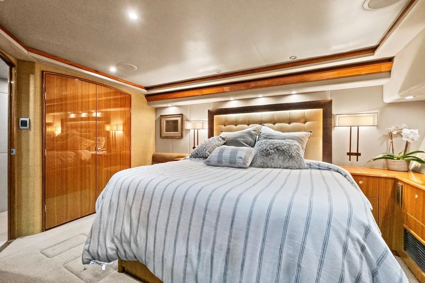 a bed with a blue comforter aboard VKY74038A808 Yacht for Sale