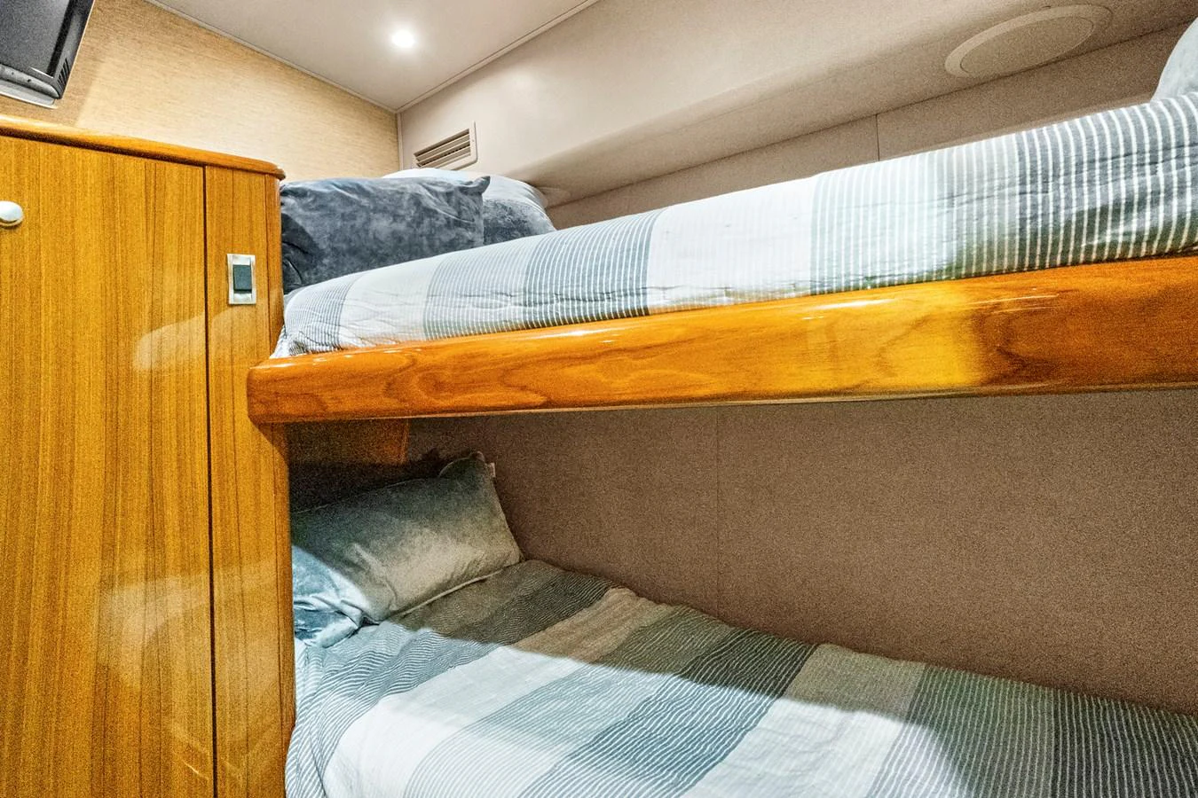 a bed with a wooden headboard aboard VKY74038A808 Yacht for Sale