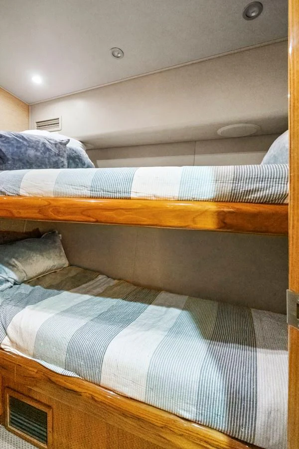 a bunk bed with a blue and white striped comforter aboard VKY74038A808 Yacht for Sale