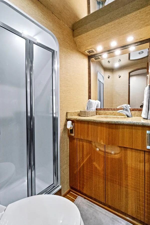 a bathroom with a glass shower aboard VKY74038A808 Yacht for Sale