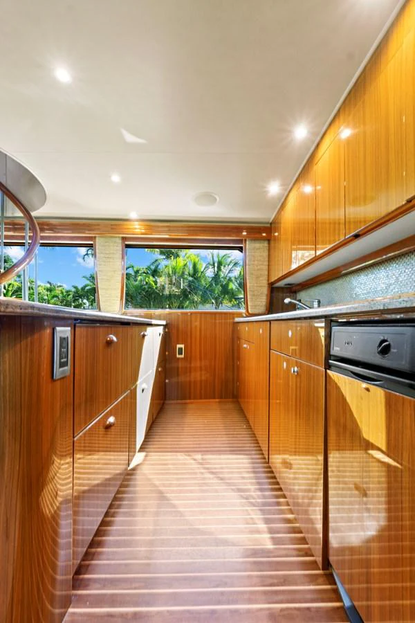 a kitchen with wooden cabinets aboard VKY74038A808 Yacht for Sale