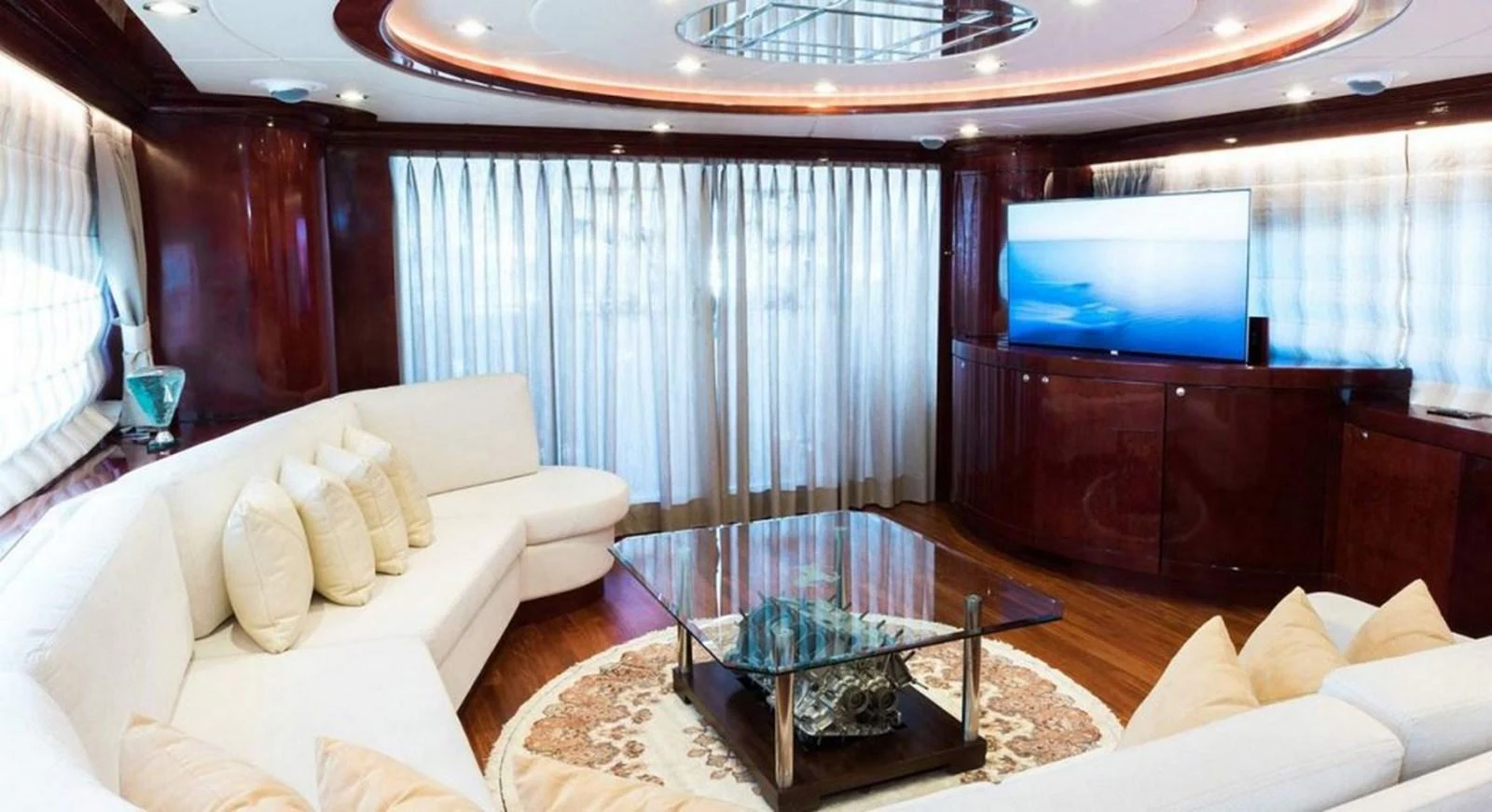 a living room with a large television aboard ALBATOR 2 Yacht for Sale